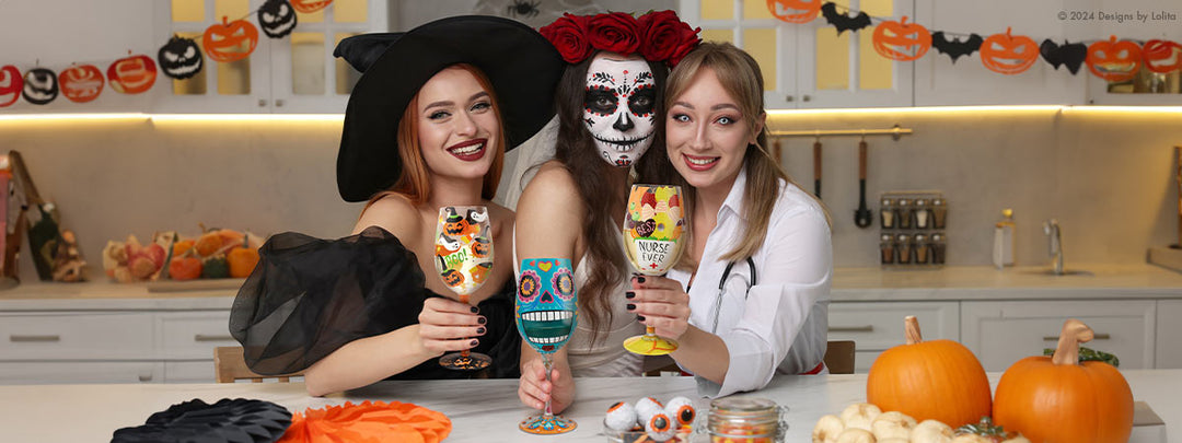 3 girls in costume holding halloween cocktail glasses