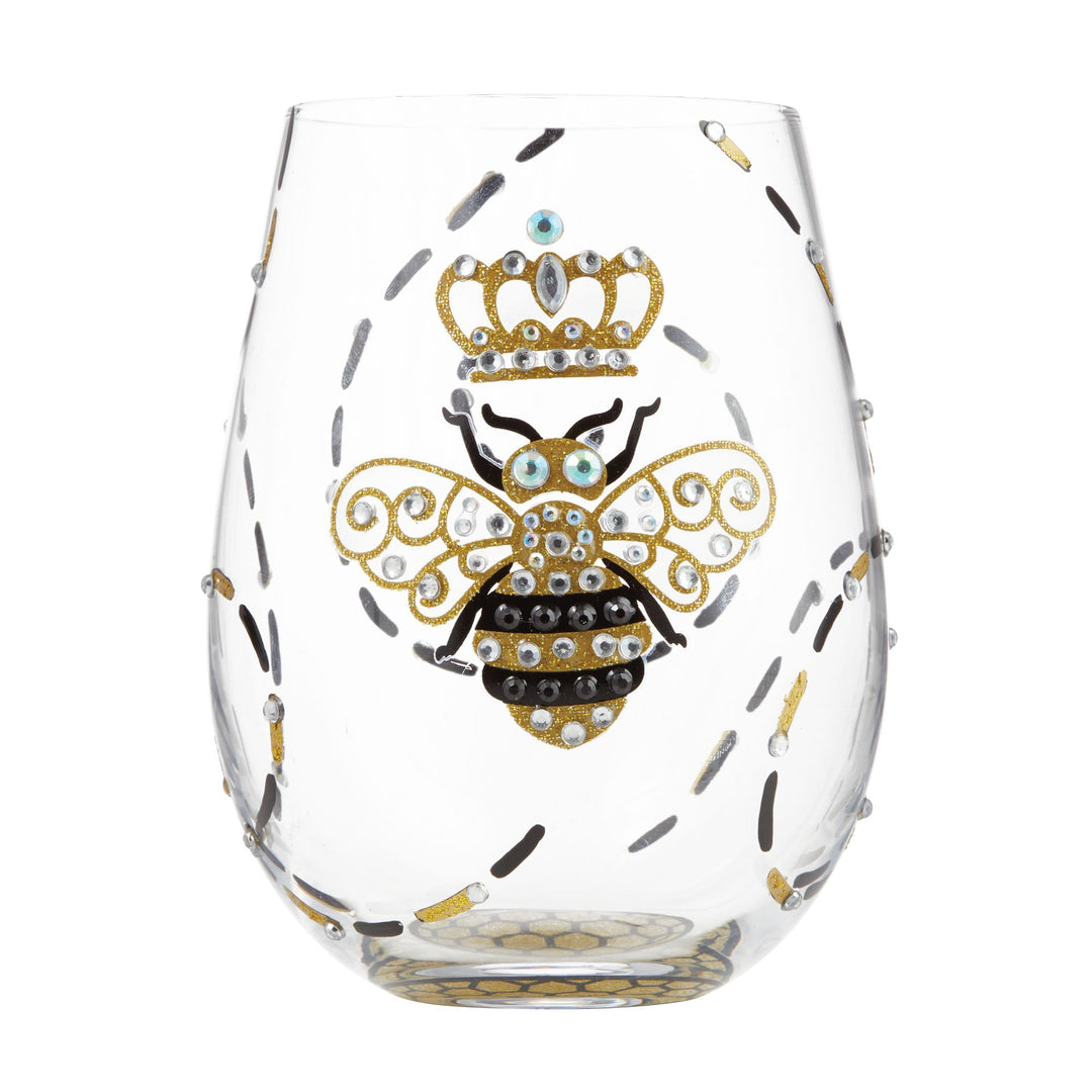 A hand-painted stemless wine glass with a design of a bee wearing a crown, surrounded by floral patterns and crystal accents.